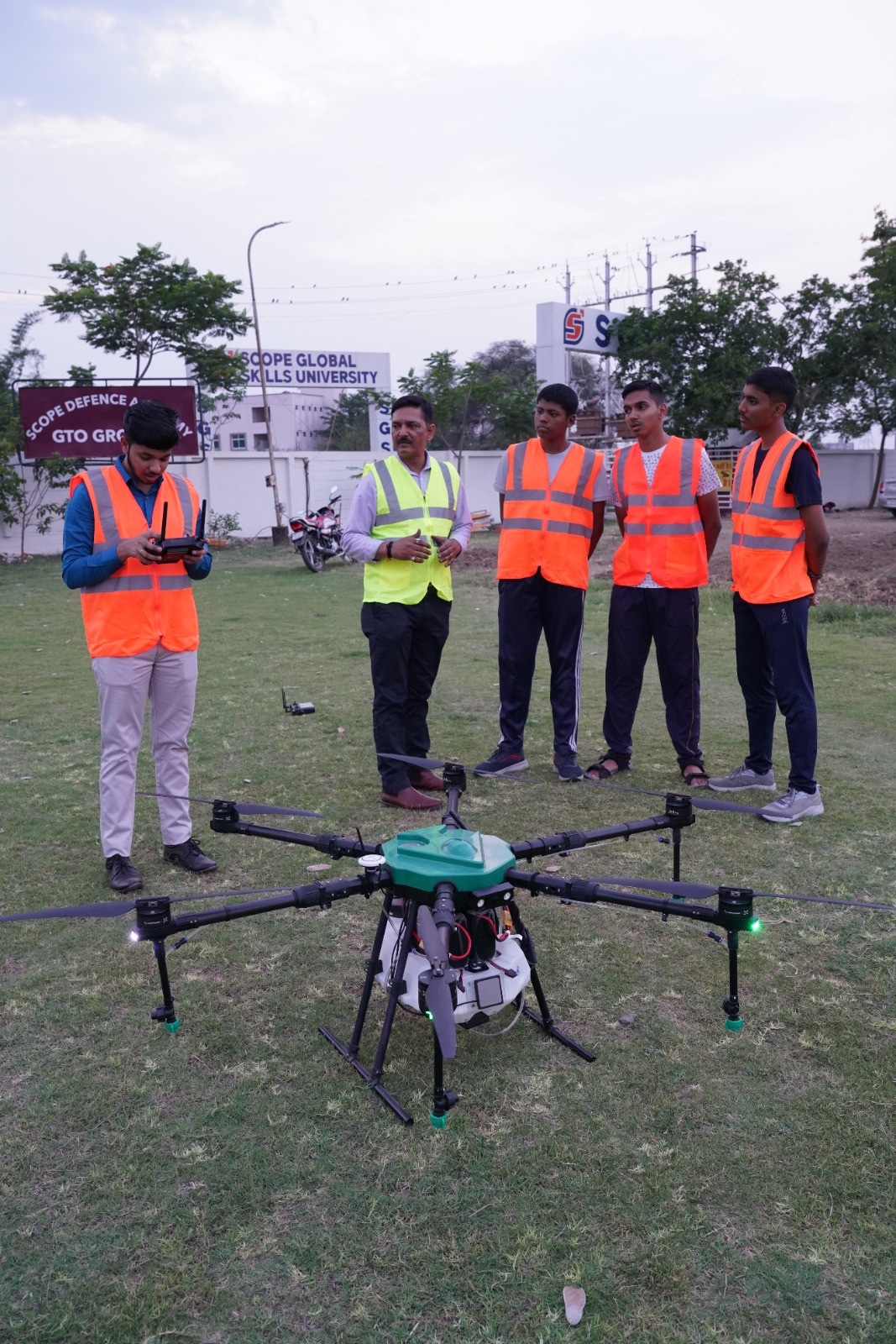 Close up of a sophisticated commercial drone sitting on a landing pad with technical equipment and flight logs in a training environment