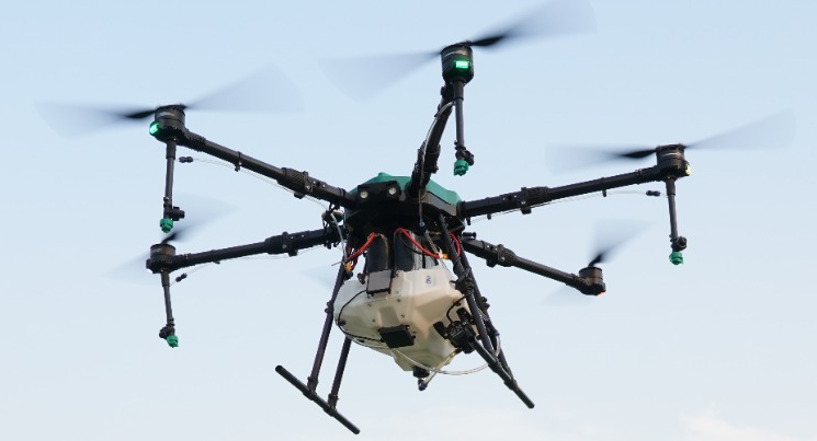cinematic close-up of a high-tech white quadcopter drone mid-flight against a clear blue sky with sunlight reflecting off the carbon fiber blades